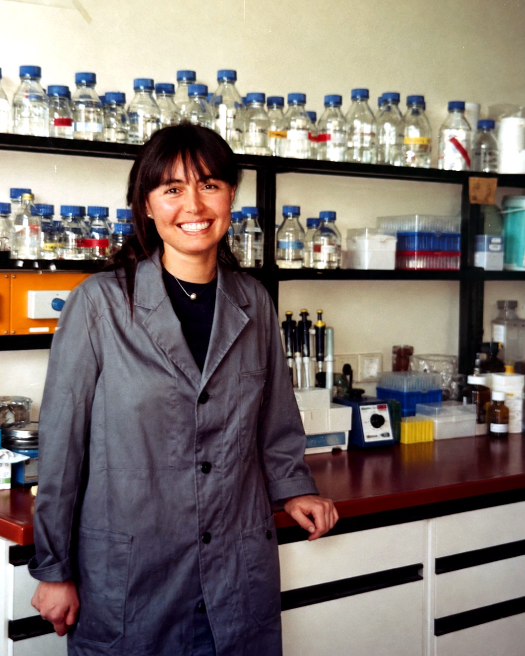 Dr Monica Takamiya Wik standing in a molecular plant biology laboratory during her PhD research.